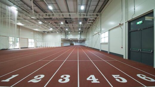 Close-up of the numbered starting line (lanes 1-6) on the indoor, straight-line sprint track at Sutcliffe Park.